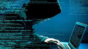 A hacker in a dark hoodie working on a laptop surrounded by lines of code, representing a cyber-attack.