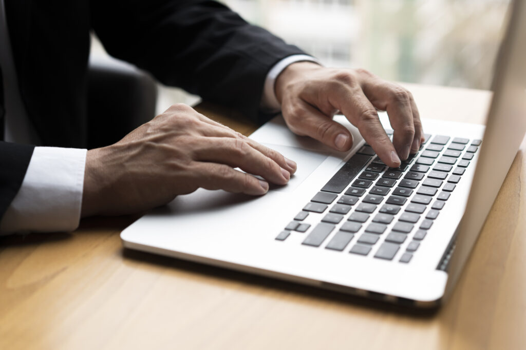 Hands typing on a laptop during a server migration process