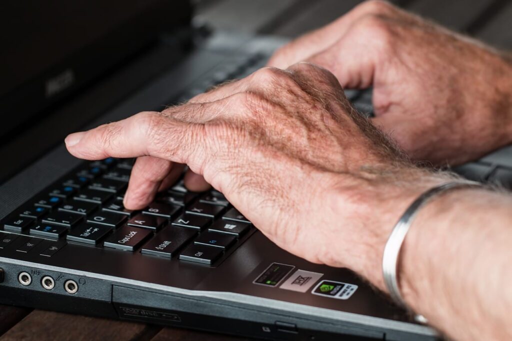 Hands typing on a laptop during a server migration